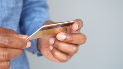 close-up of a man holding a credit card