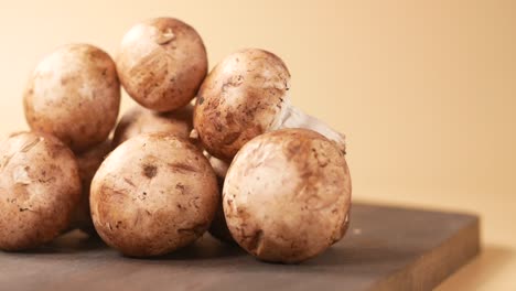 close-up of fresh brown mushrooms on a wooden cutting board