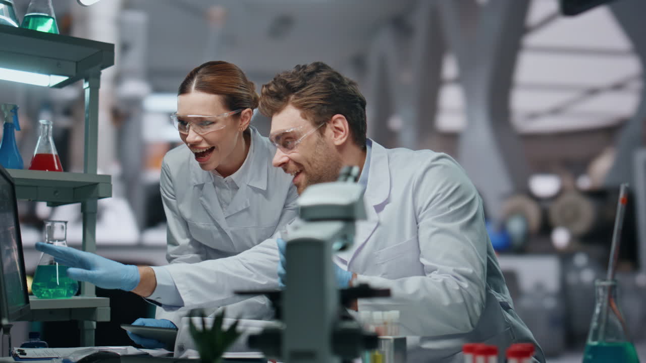 Happy laboratory colleagues working in clinic close up. Scientists giving five