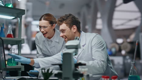 happy laboratory colleagues working in clinic close up. scientists giving five