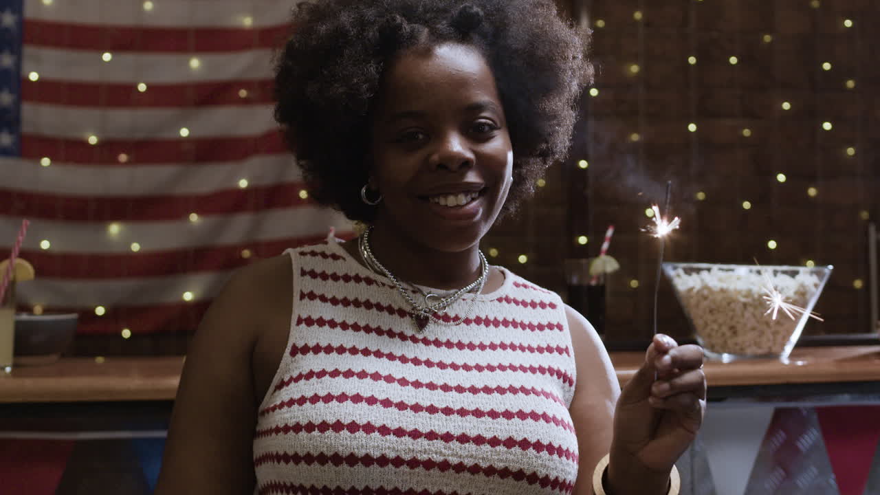 Woman with Sparkler at a 4th of July Party