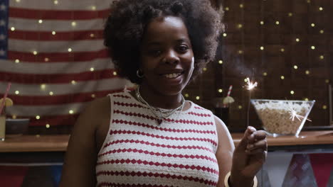 woman with sparkler at a 4th of july party