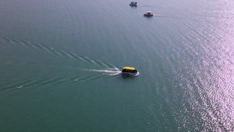 spectacular 360 aerial view of boats in ocean at sunset