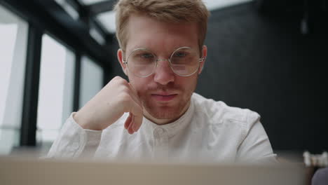 financial analyst or lawyer is reading concentrated text on laptop display searching for information in internet