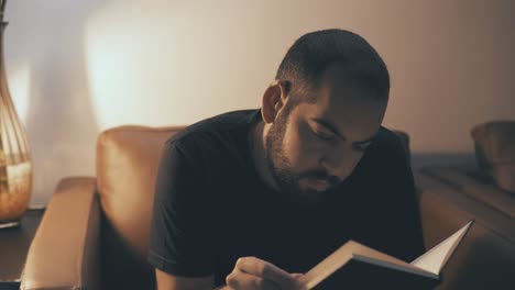 young bearded man reading in 4k uhd