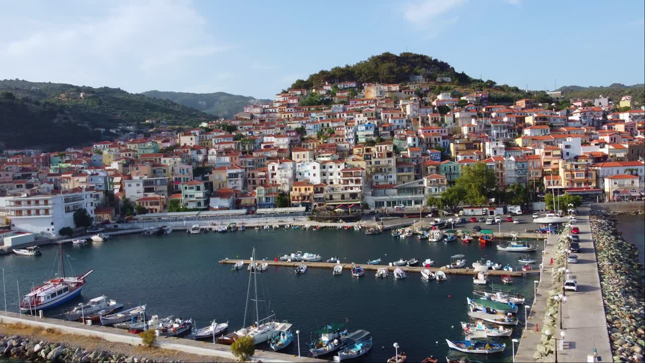 Beautiful Plomari town port with tile roofed old traditional houses, Lesvos Island, Aegean sea, Drone shot