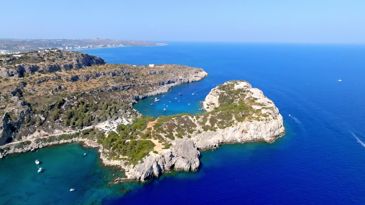 Establishing drone shot of the Anthony Quinn bay, sunny day in Rhodes, Greece