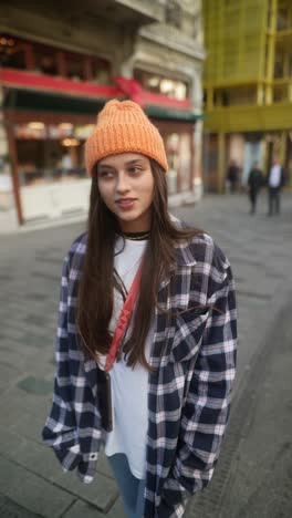 young woman walking through a city street