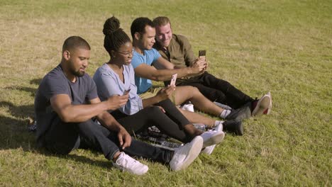 smiling young people taking selfie with smartphones