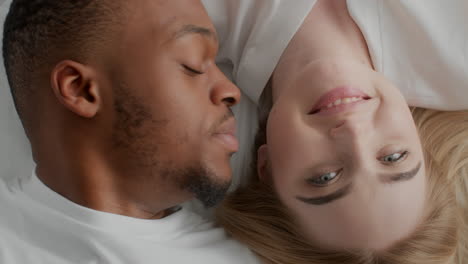 couple lying in bed kissing