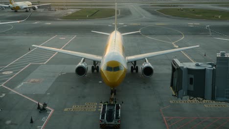 plane pushing off from gate at airport