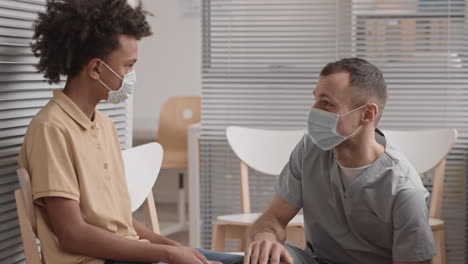 cheerful doctor talking to child patient