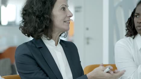 smiling businesswoman talking with coworkers