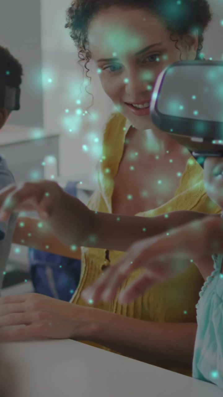 Animation of particles of light over diverse female teacher and pupils in vr headsets in classroom