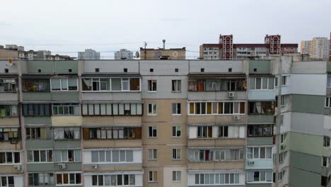 Aerial-view-of-old-soviet-architecture-buildings,-in-a-poor-ghetto-district-of-Kyiv,-overcast-day,-in-Kiev,-Ukraine---tracking,-drone-shot