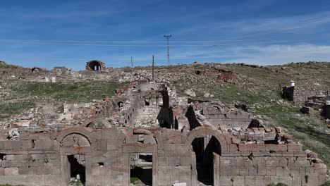 View-from-above-of-the-rock-ruins-at-Üçkuyu-village-Değle-ruins,-historical-rock