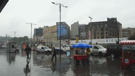 eminonu district in istanbul on rainy day with traffic and passenger waiting for ferry near the pier