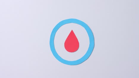 Close-up-of-blood-drop-in-blue-circle-on-white-background,-copy-space,-slow-motion