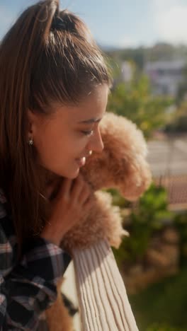 woman with dog on balcony