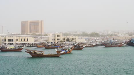 dhow fishing boat floating at dubai creek with calm water in dubai, uae, middle east