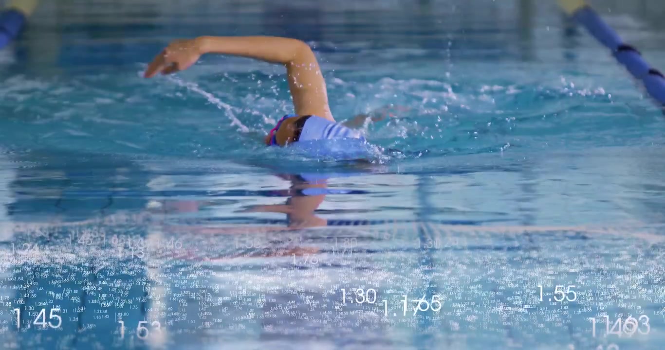 Starting submerged female athlete training freestyle swimming in lap pool with floating lane ropes