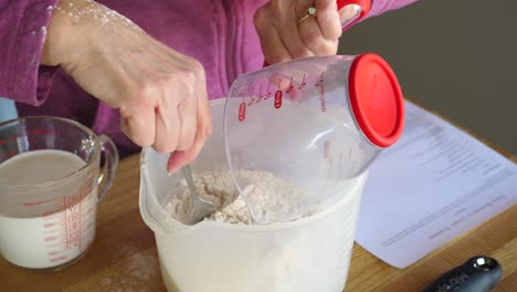 adding ingredients from measuring cup - making scones slow motion