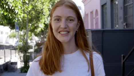 portrait of a young woman smiling in the street