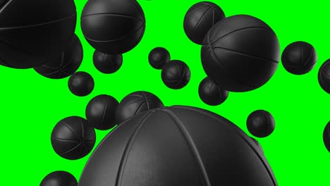 muchas bolas de baloncesto negras en llave de croma verde.
