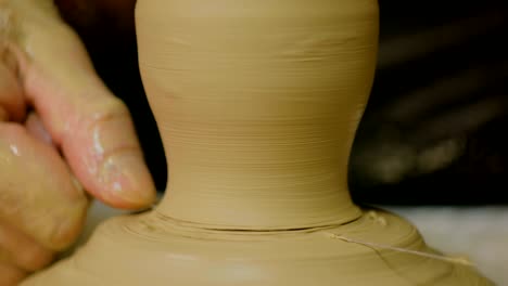 professional male potter working in workshop, studio