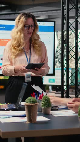vertical video general director hosting a briefing session with her team to present data