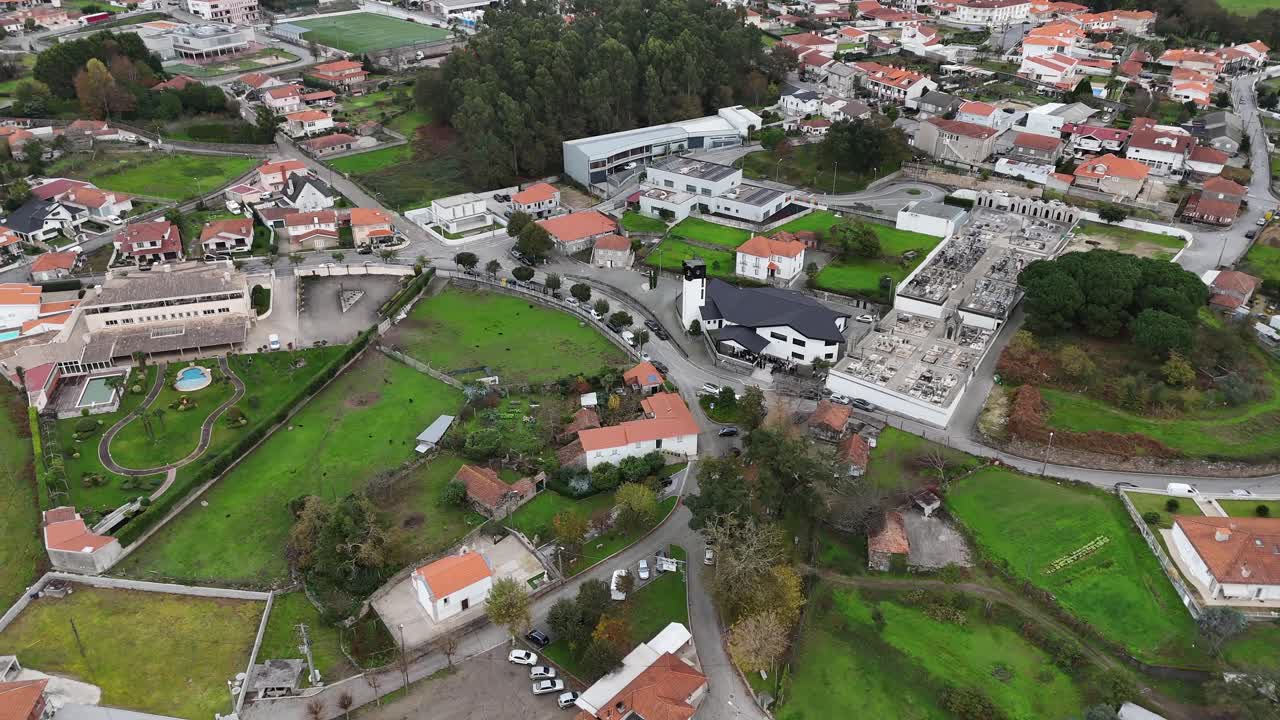 Aerial - São Tiago de Figueiró with houses, church, and green spaces in Paços de Ferreira