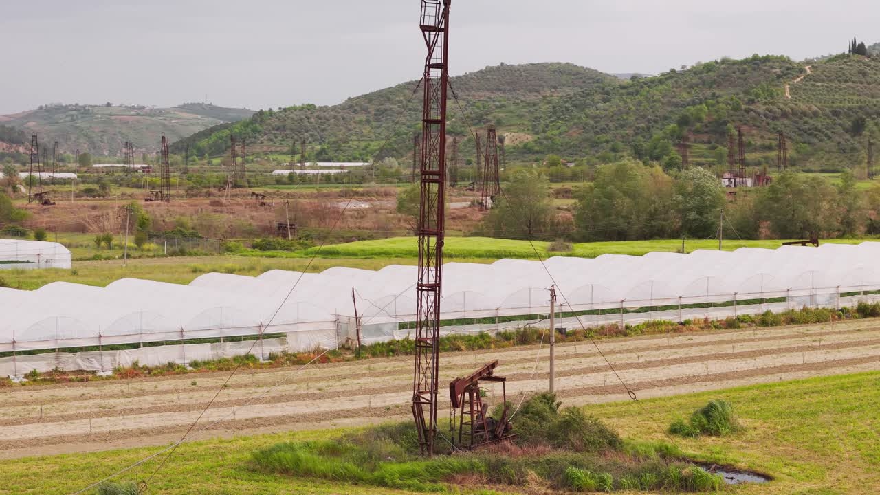 Albanian countryside oil field with rustic feel and serene landscape