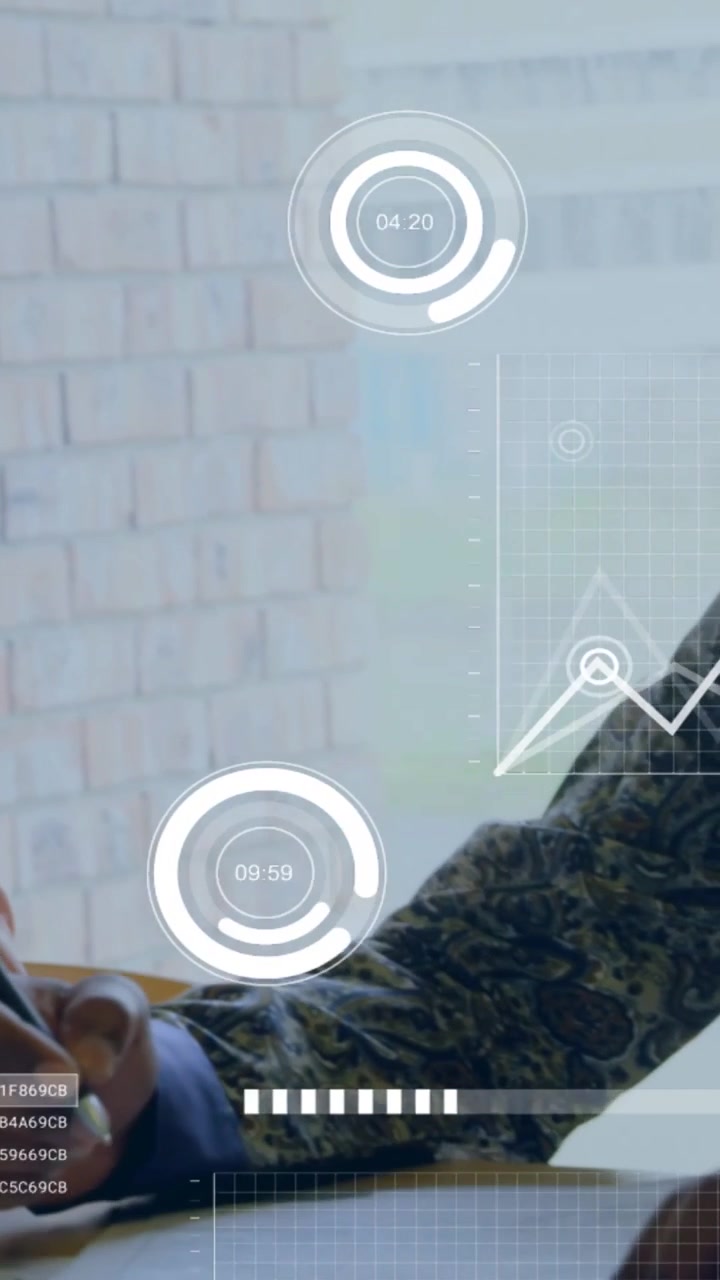 Vertical video: Man using tablet, picking pen and passing to peer, HUD charts tracking work in tech
