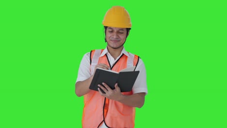 Happy-Indian-architect-noting-down-points-of-the-building-Green-screen
