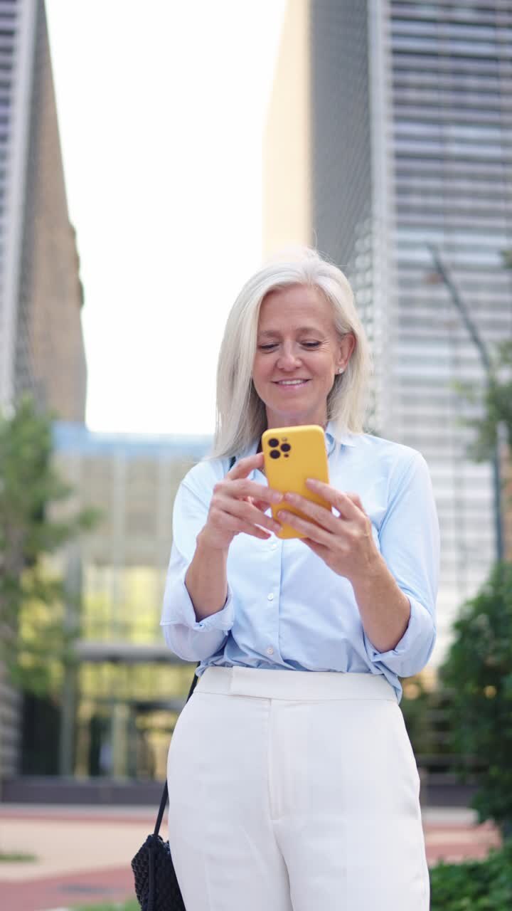 Woman using her phone in the city