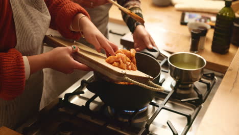 woman in kitchen cooking chicken