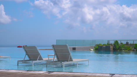 submerge sun loungers at the pool on renaissance bali uluwatu resort and spa in bali, indonesia