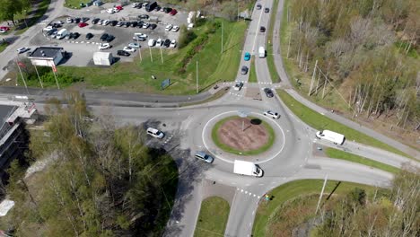 Aerial-Time-Lapse-Of-Cars-Driving-Through-A-Roundabout-By-A-Parking-Lot-In-Gothenburg