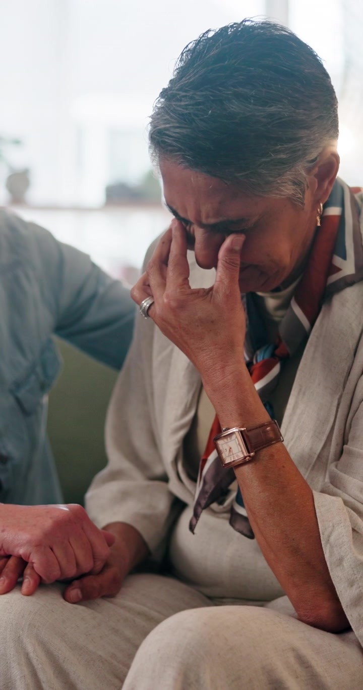 Senior Woman Crying While Being Comforted by Partner