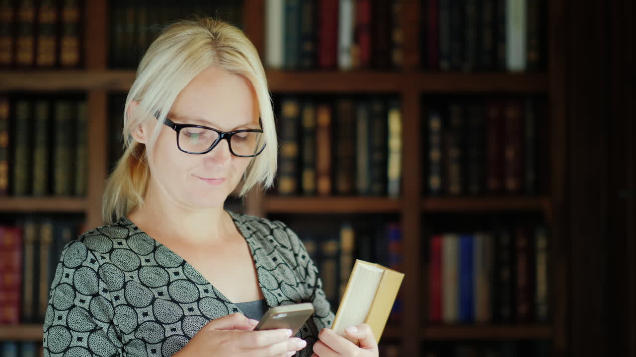 Woman Holding Book Using Smartphone