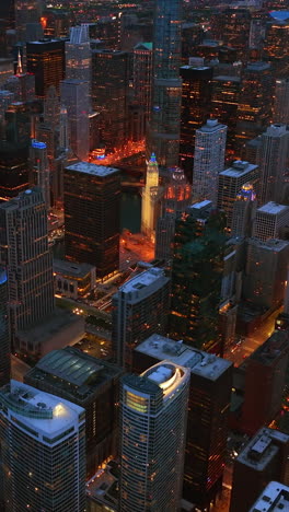 evening sight of amazing chicago scenery. well-lit streets going among the sparkling skyscrapers from aerial perspective. vertical video