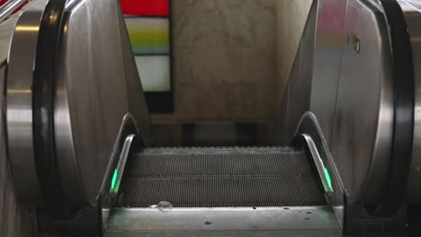 empty escalator going down in a subway station