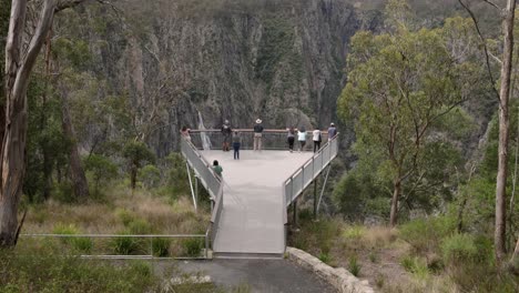 hand held shot of people on the viewing platform of wollomombi falls lookout, oxley wild rivers national park, new south wales, australia