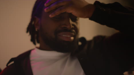 close up of man waking up on sofa after drinking alcohol at house party suffering with hangover 5