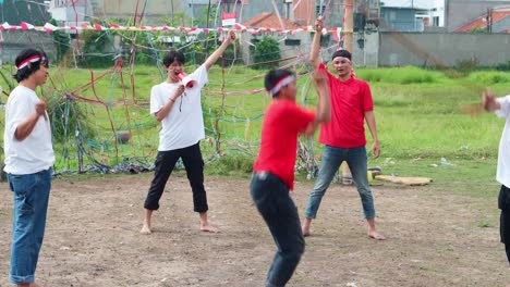 young indonesian men celebrating independence day with variety of traditional games and activities playing jumping rope