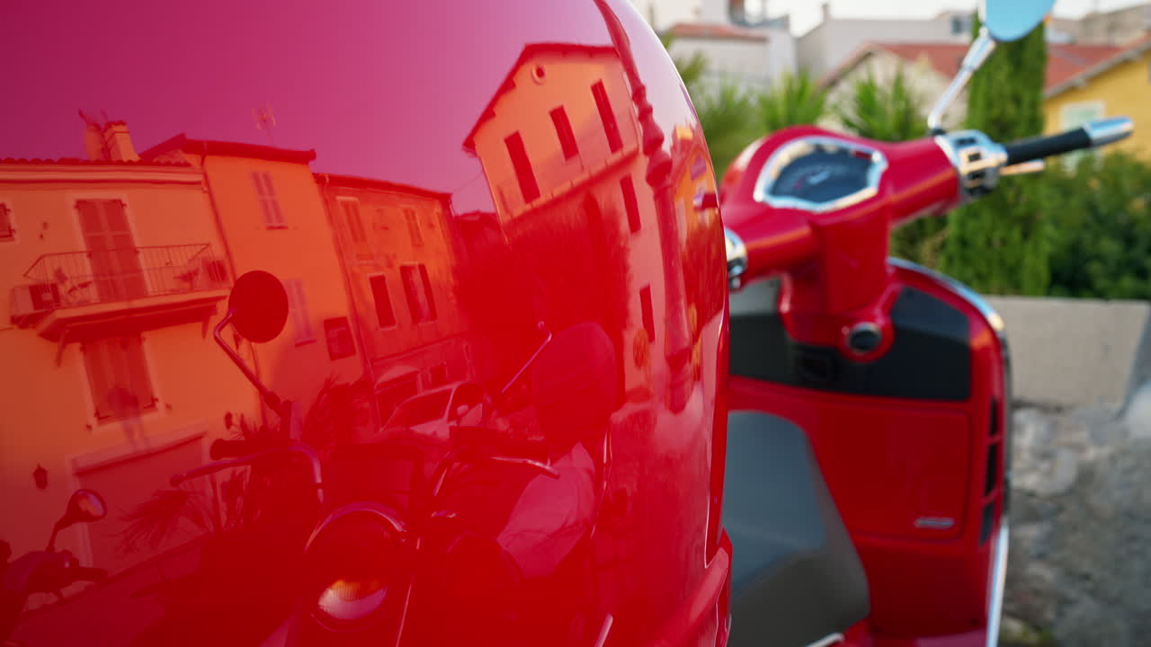 Close up of the back of a red scooter parked on the street in Antibes, France
