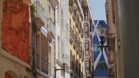 handheld slow motion clip of a narrow street in gijon, asturias