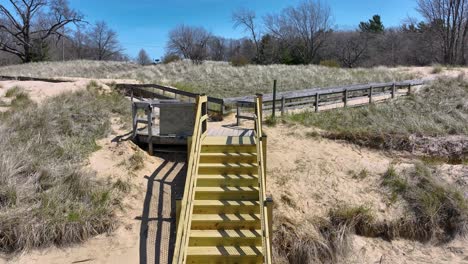 moving toward the raw lumber staircase for dune transversal