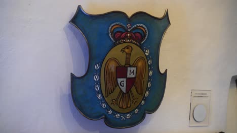 close up of shield inside dracula castle, with detailed emblem design and historical ambiance