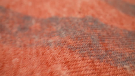 macro close-up over the cotton fabric of an orange t-shirt